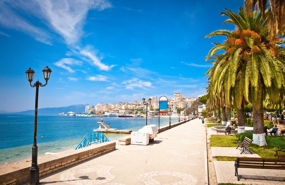 Sarandë seaside promenade in Albania summer lined with palm trees and coastal city views