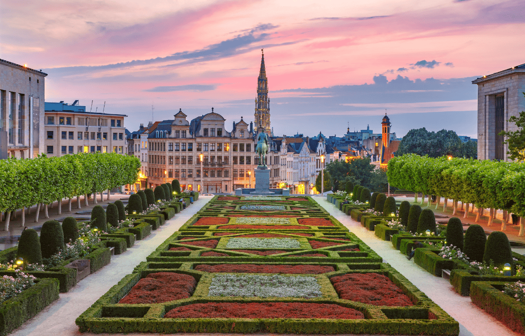 Sunset over Mont des Arts garden in Brussels, Belgium with historic architecture and manicured flower beds