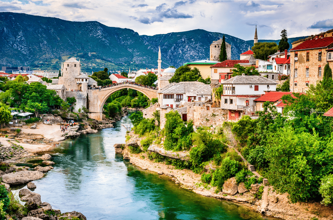 Picturesque view of Mostar's Old Bridge and traditional architecture over the emerald Neretva River – cultural hidden gem in the Balkans
