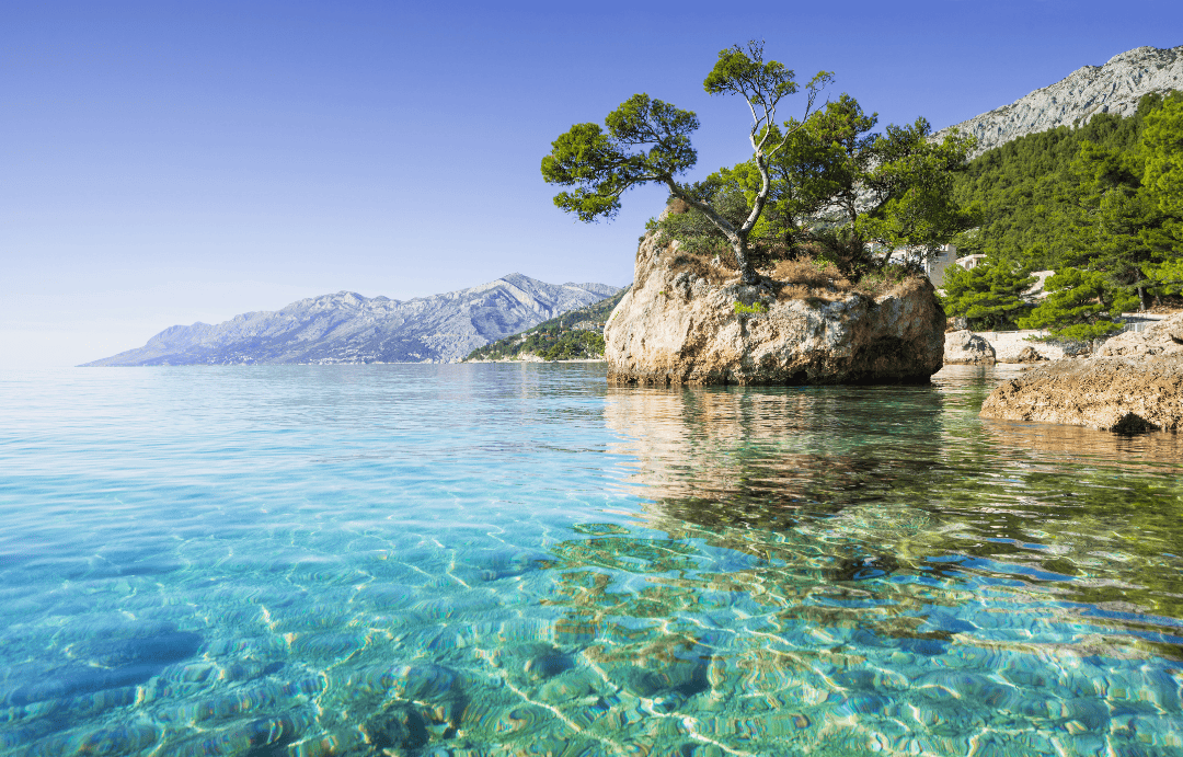 Transparent turquoise waters and iconic coastal rock in Brela, one of the best beaches in Croatia