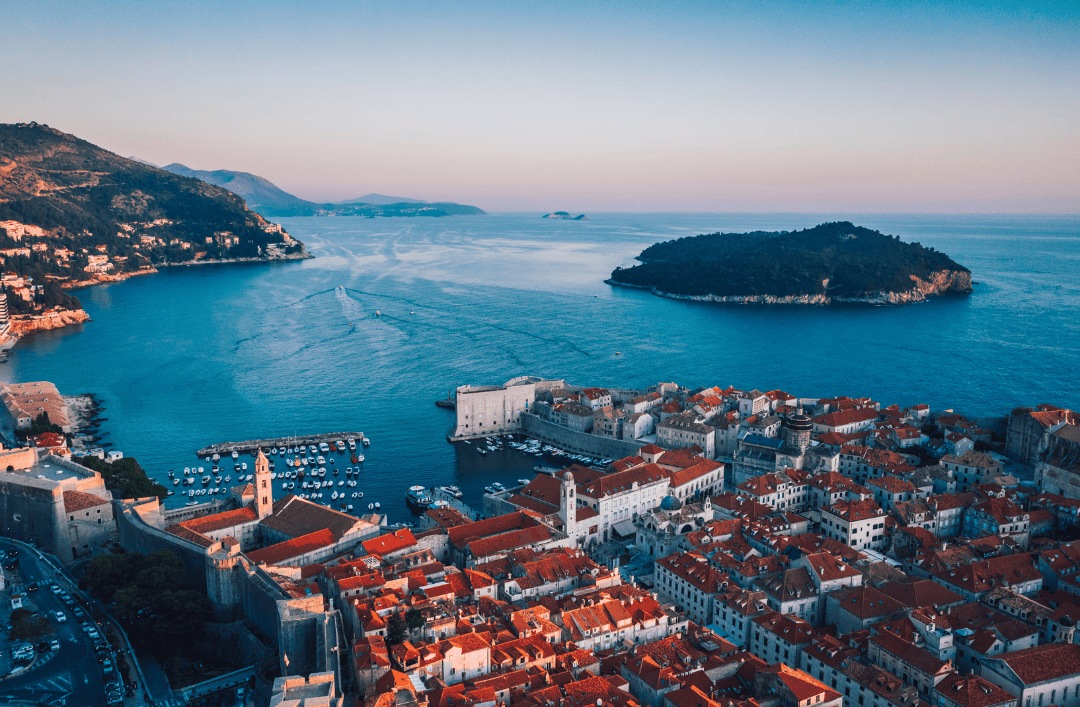 Aerial sunset view of Dubrovnik, Croatia with Lokrum Island and marina – a top summer travel destination.