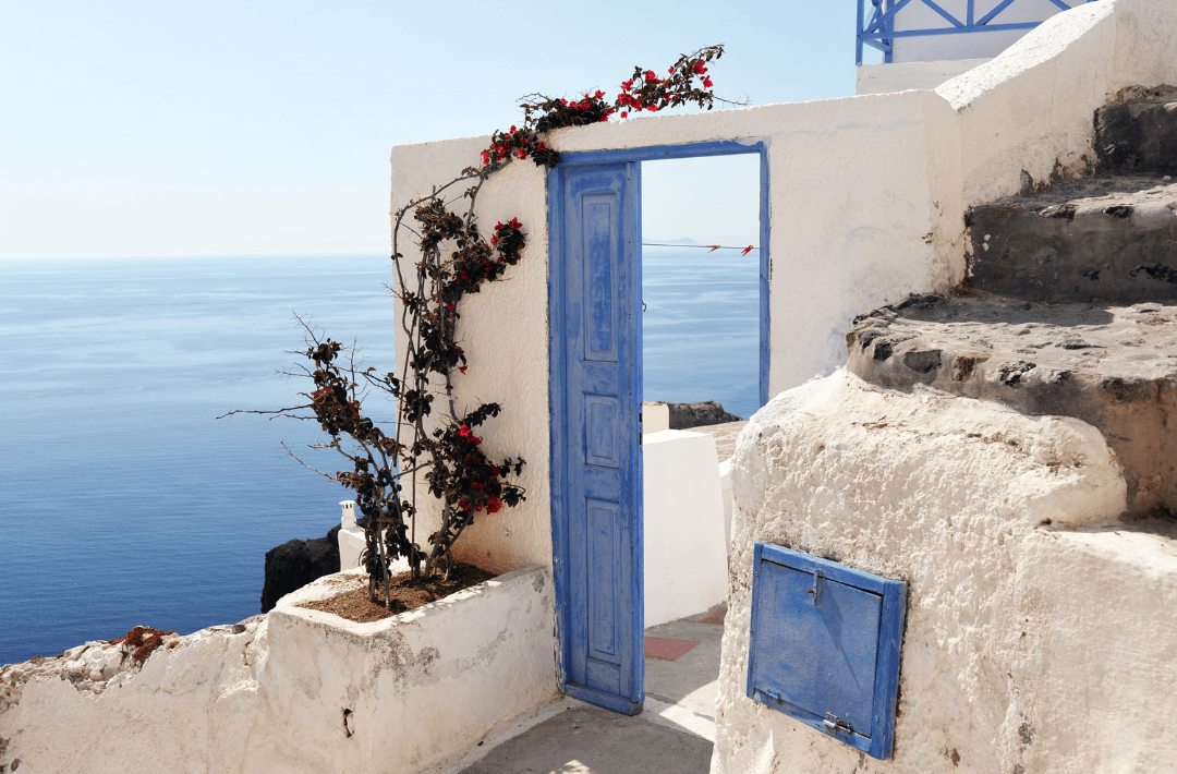 Traditional blue door overlooking the Aegean Sea in Santorini, Greece – free scenic spot