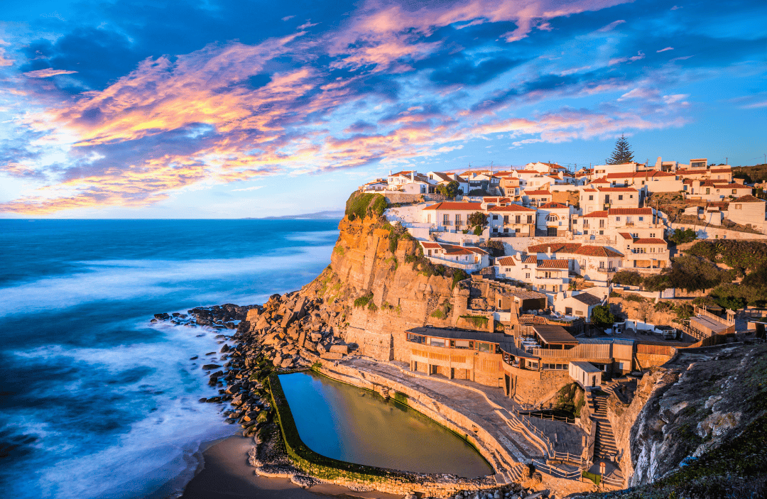 Coastal village in Portugal glowing at sunset—top destination for summer vacation 2025 in Europe.