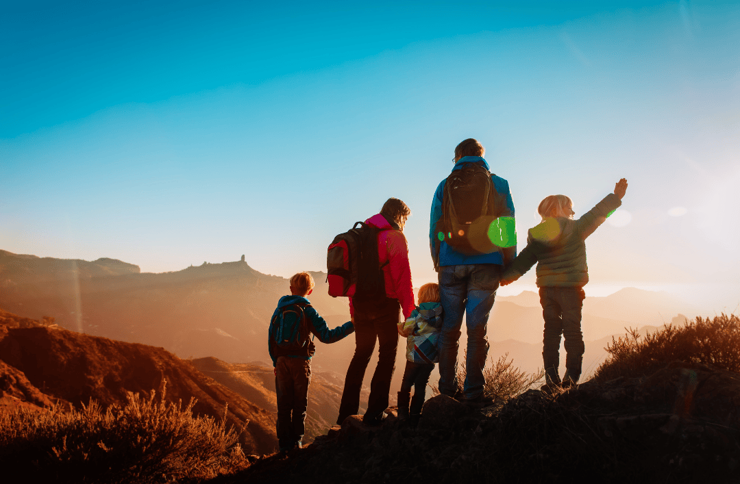 GCC family traveling with kids enjoying outdoor adventure at sunset during international trip